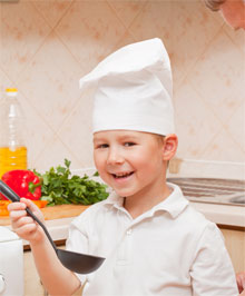 Boy tasting own cooking